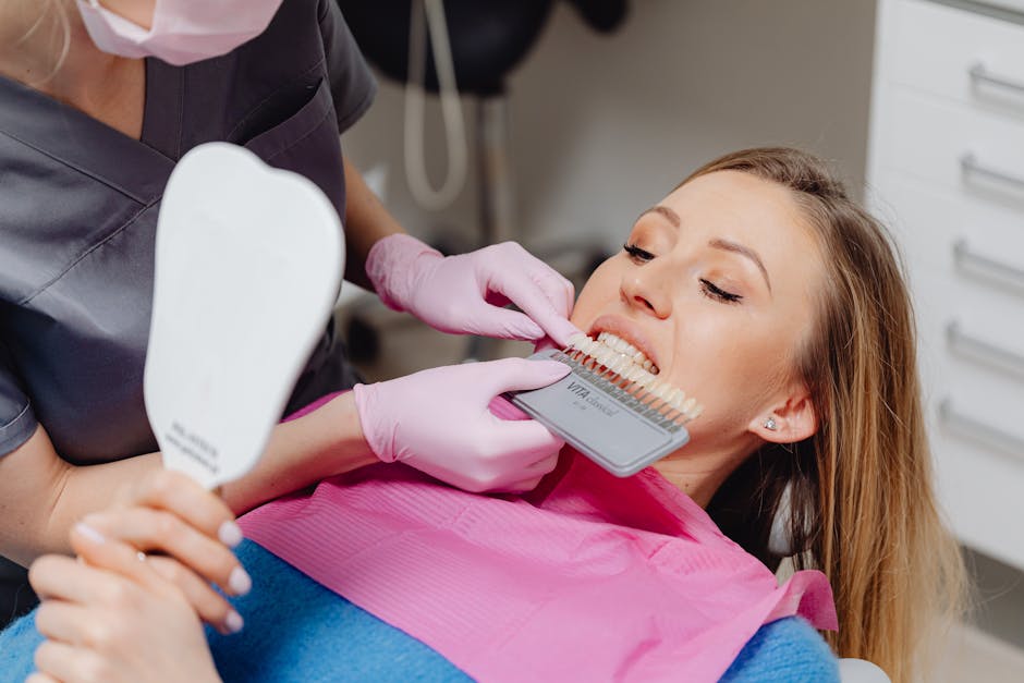 Dentist comparing tooth shades during a professional whitening visit