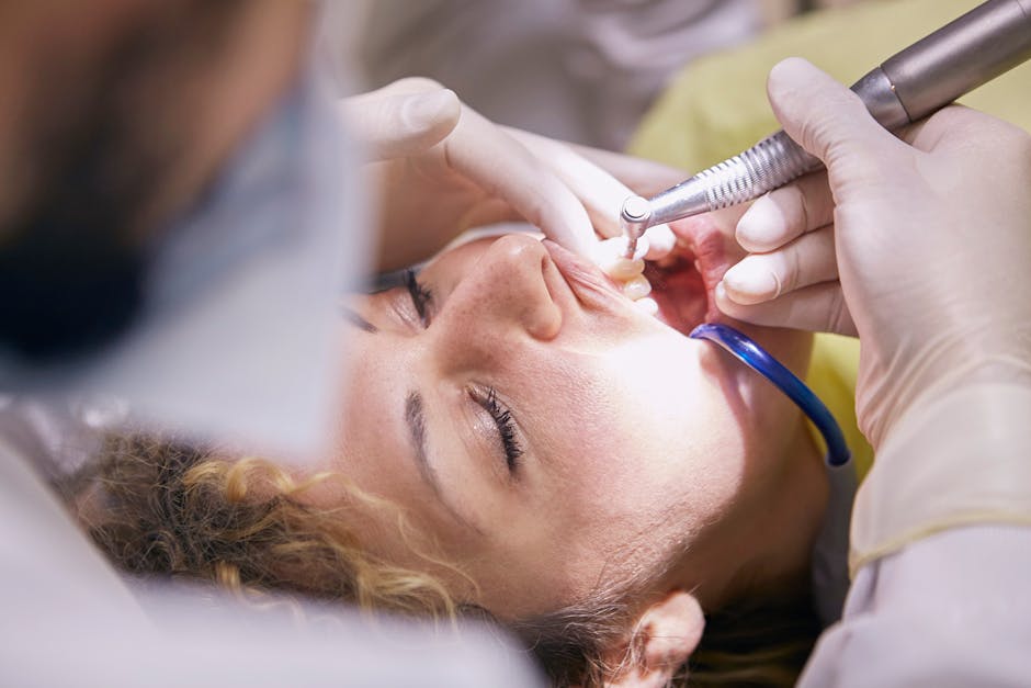 Patient receiving a routine dental cleaning and filling