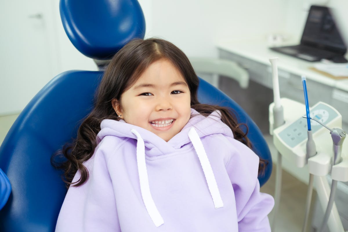 Kids dentistry CBD Belapur — a cheerful child relaxed in the dental chair at La Pearl Dental Boutique Navi Mumbai